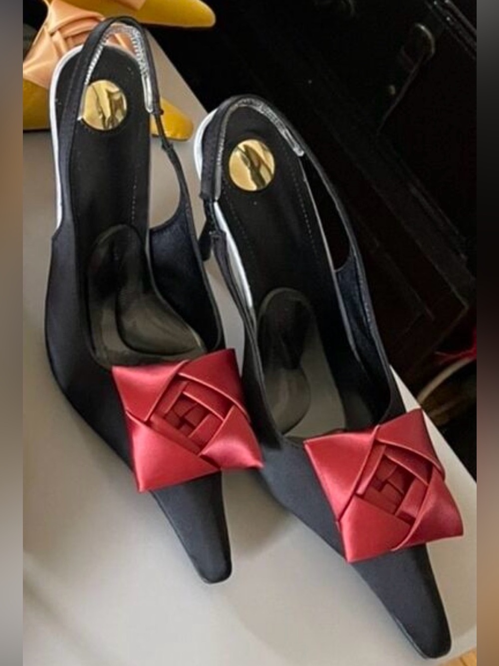 Black Slingback Pointed-Toe Pumps with Red Bow Accent